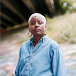 Headshot of Caresse Dionne standing under a freeway overpass