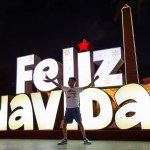 A child plays in front of a Merry Christmas sign as part of the Christmas celebrations in Venezuela