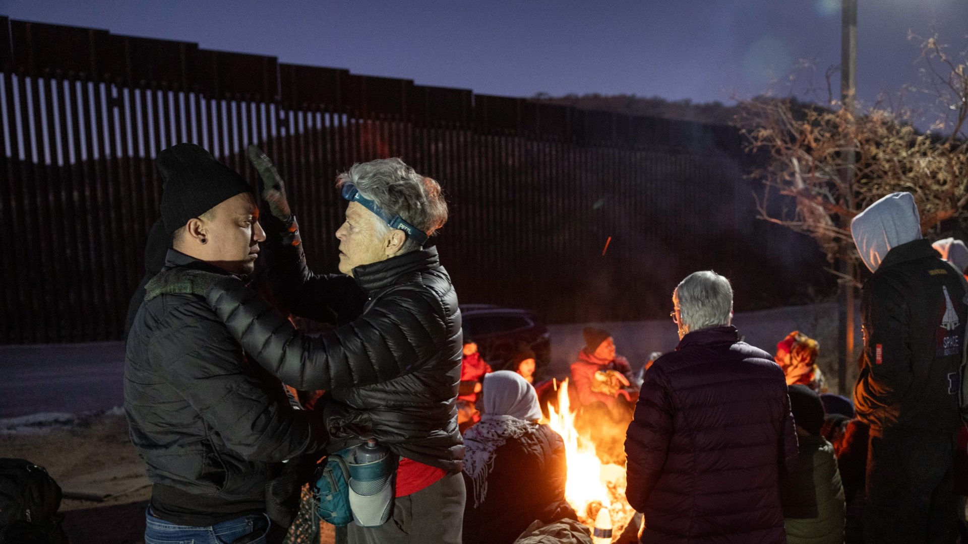 Una mujer ora por un inmigrante colombiano en Arizona mientras este esperaba ser recogido por la patrulla fronteriza la noche antes de la toma de posesión de Donald Trump.