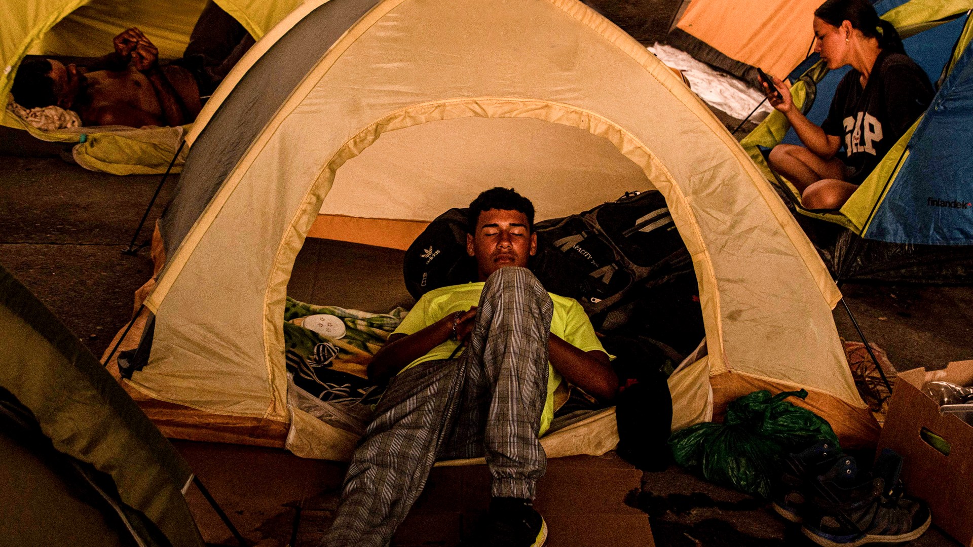 Migrant people rest at the Paso Canoas refugee camp in Puntarenas, Costa Rica