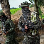 Members of a FARC dissident guerrilla group march on a rural area of Colombia.