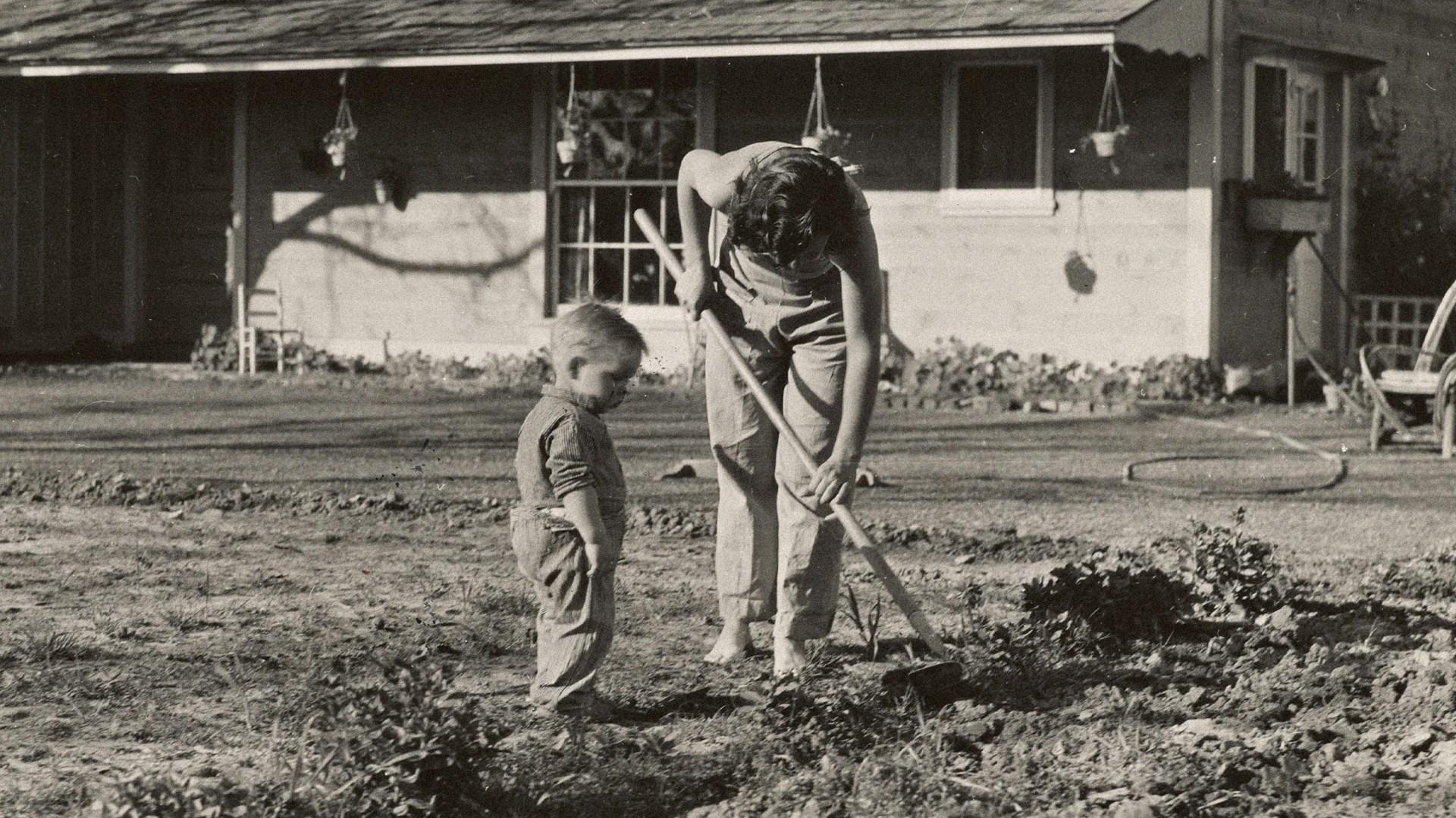 A mom and son gardening.