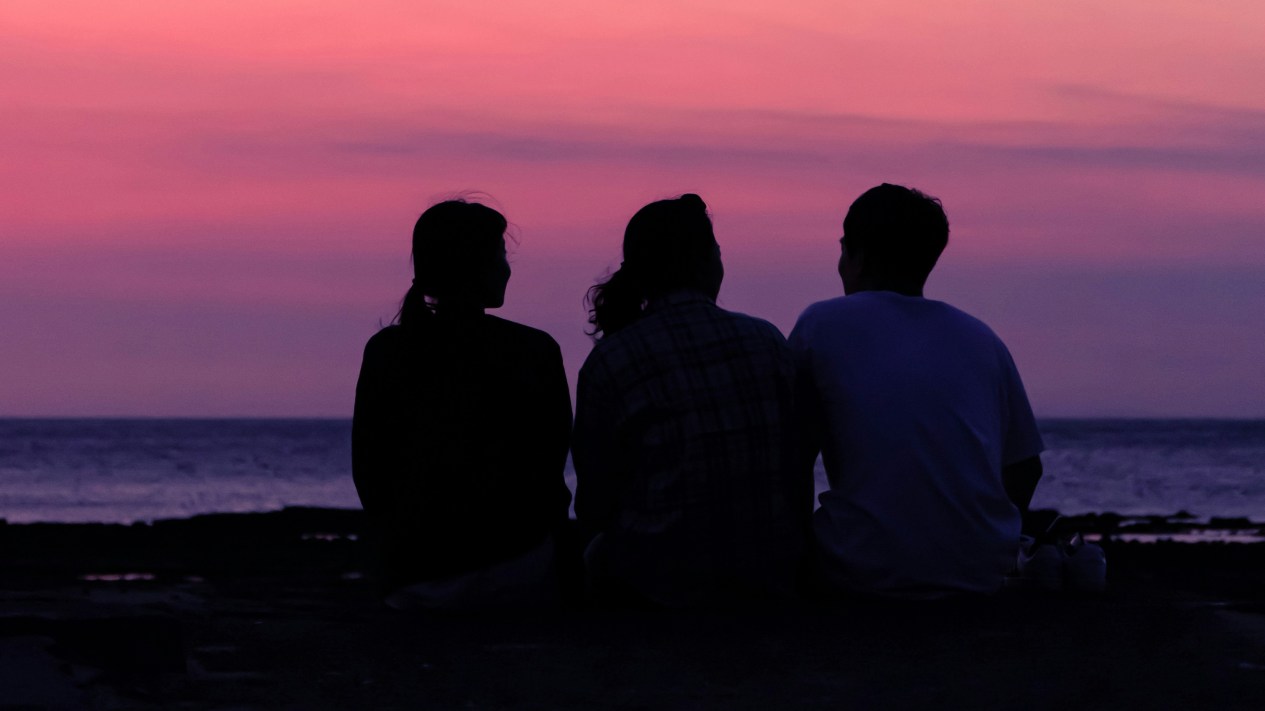 Three people in a deep conversation.